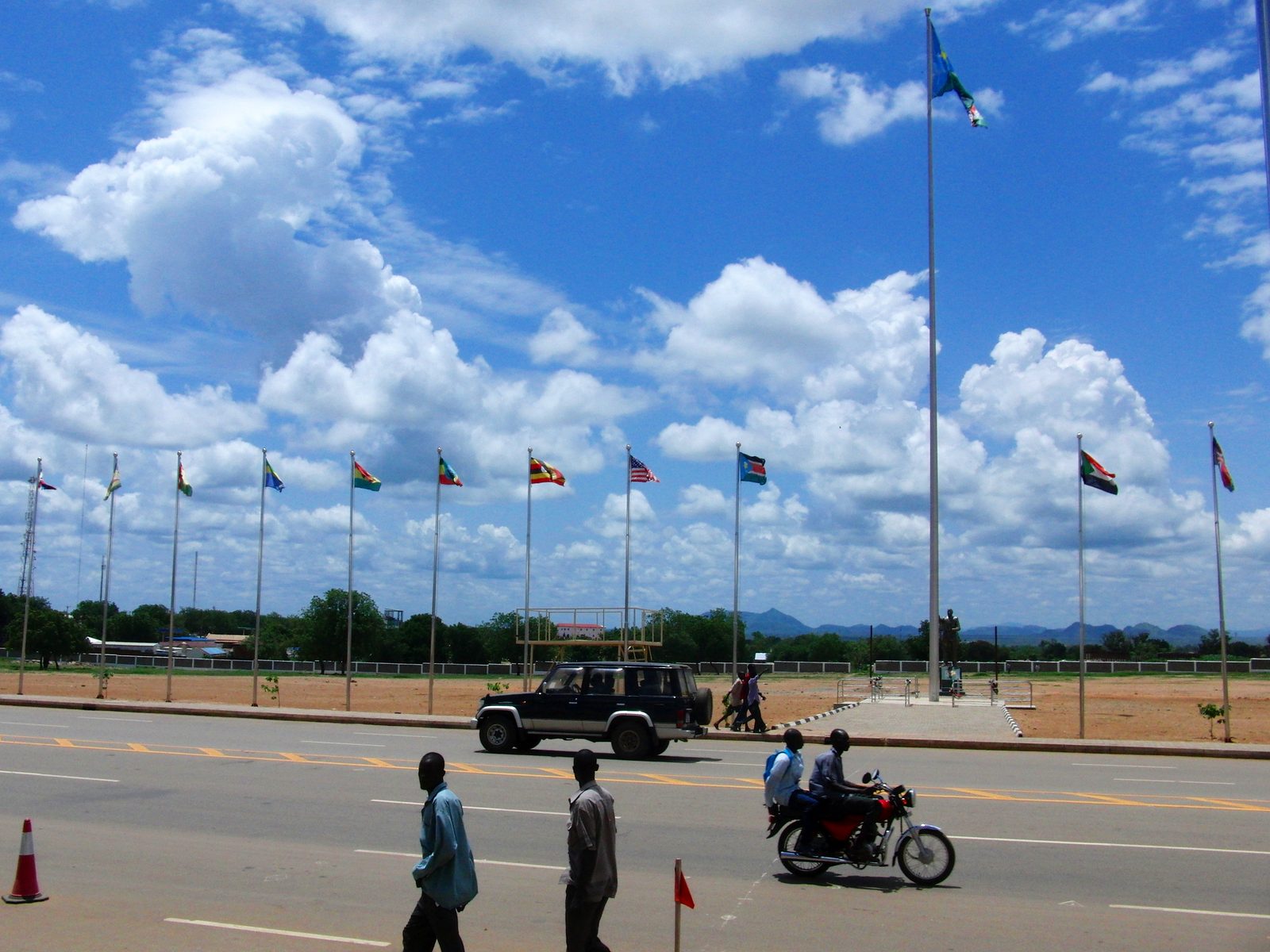 Flagpoles and the John Garang Mausoleum square in Juba, South Sudan's capital, under a wide blue sky